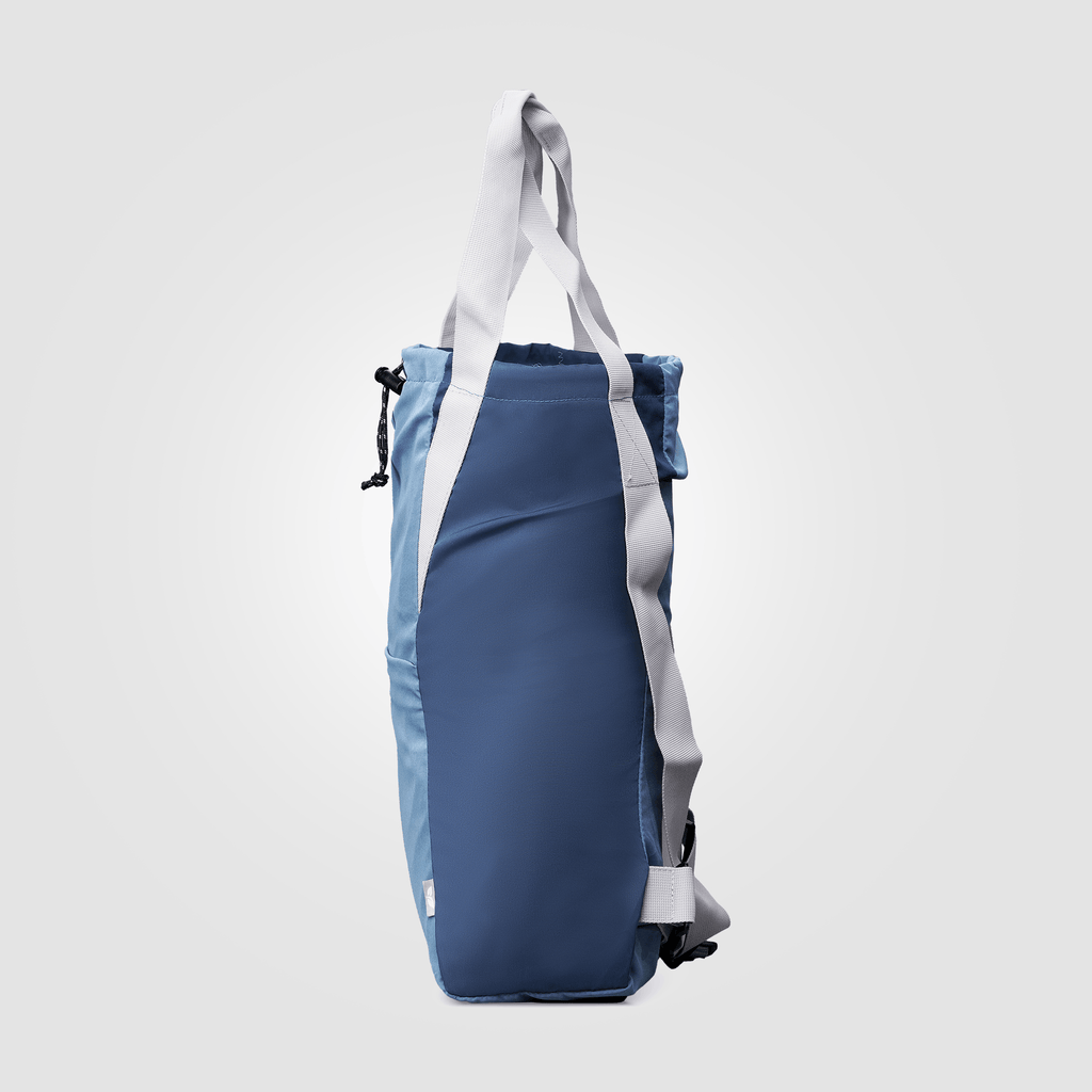 Blue backpack with white straps on a light gray background