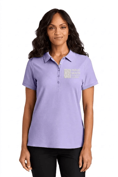 Woman wearing a lavender polo shirt with a logo on a white background